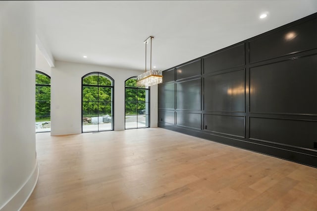 10007 Allen Dr, Dublin, OH 43017 - unfurnished room with a decorative wall, recessed lighting, light wood-style flooring, and a chandelier