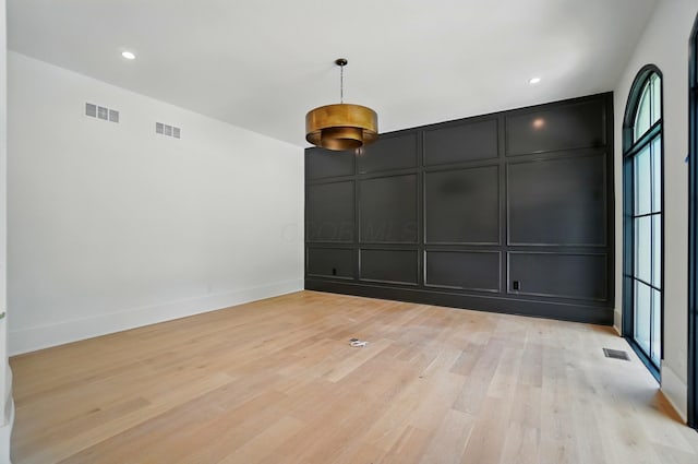 10007 Allen Dr, Dublin, OH 43017 - empty room with a decorative wall, plenty of natural light, light wood-style floors, and baseboards