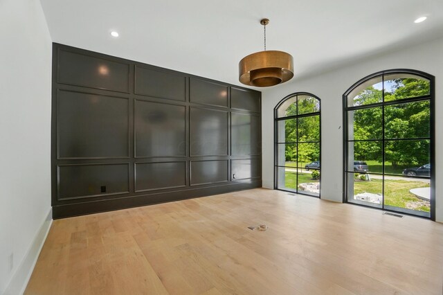 10007 Allen Dr, Dublin, OH 43017 - empty room with a decorative wall, light wood-style flooring, and recessed lighting