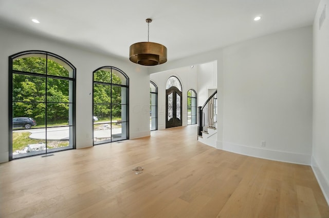 10007 Allen Dr, Dublin, OH 43017 - spare room featuring light wood finished floors, stairway, baseboards, and recessed lighting