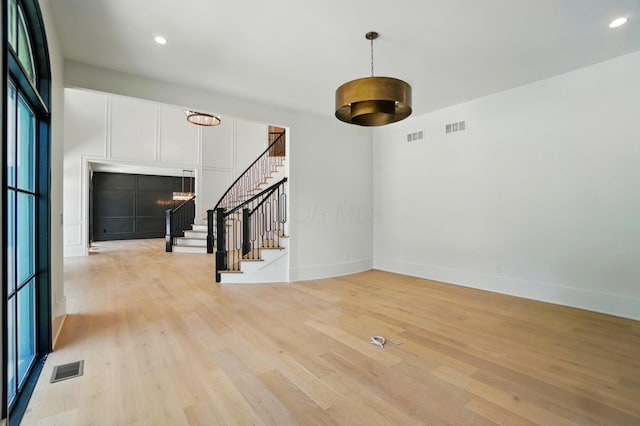 10007 Allen Dr, Dublin, OH 43017 - unfurnished living room with light wood-style flooring, stairway, baseboards, and recessed lighting