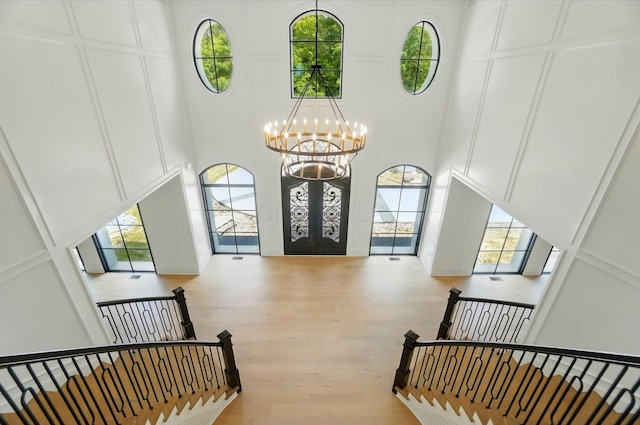 10007 Allen Dr, Dublin, OH 43017 - foyer featuring a high ceiling, a chandelier, wood finished floors, healthy amount of natural light, and french doors