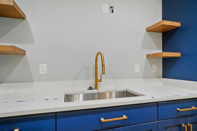 10007 Allen Dr, Dublin, OH 43017 - kitchen with open shelves, a sink, blue cabinets, and light countertops