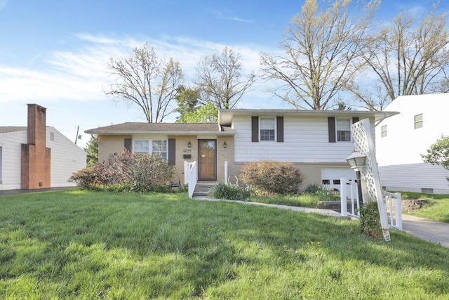6693 Red Coach Ln, Reynoldsburg, OH 43068 - tri-level home featuring brick siding, a front lawn, and a garage