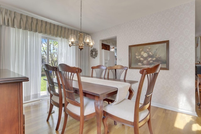 6693 Red Coach Ln, Reynoldsburg, OH 43068 - dining room featuring a chandelier, wallpapered walls, light wood-style floors, and baseboards