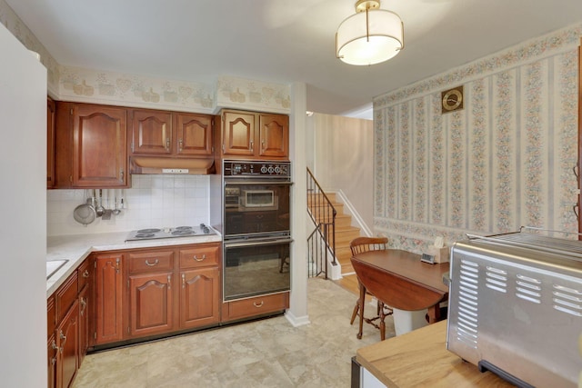 6693 Red Coach Ln, Reynoldsburg, OH 43068 - kitchen featuring decorative backsplash, custom range hood, electric stovetop, light countertops, and dobule oven black