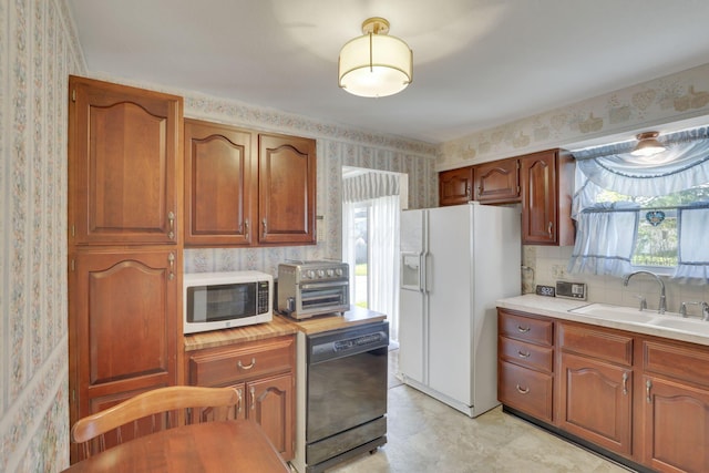 6693 Red Coach Ln, Reynoldsburg, OH 43068 - kitchen featuring a sink, a healthy amount of sunlight, wallpapered walls, a toaster, and white appliances