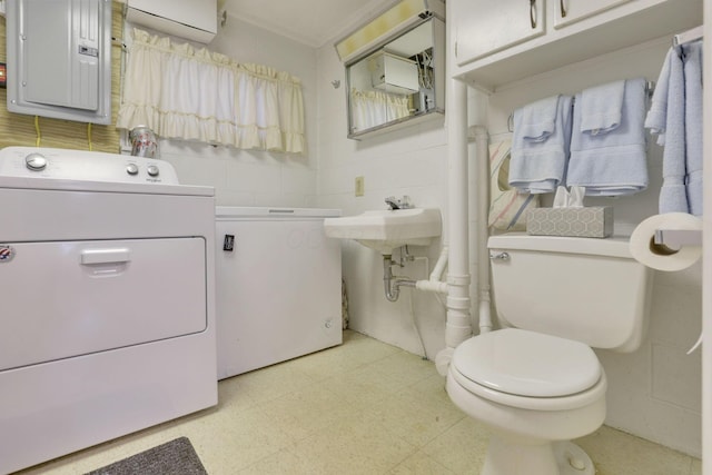 6693 Red Coach Ln, Reynoldsburg, OH 43068 - bathroom featuring tile patterned floors, toilet, electric panel, a sink, and washer and clothes dryer