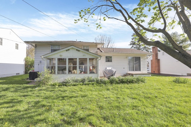 6693 Red Coach Ln, Reynoldsburg, OH 43068 - rear view of house with a sunroom, central air condition unit, and a lawn