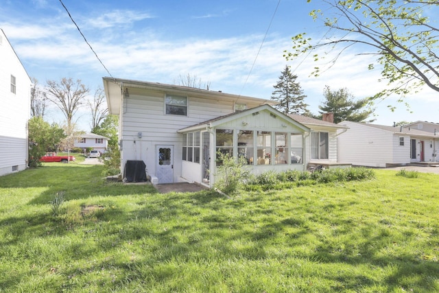 6693 Red Coach Ln, Reynoldsburg, OH 43068 - rear view of house featuring a lawn and a sunroom