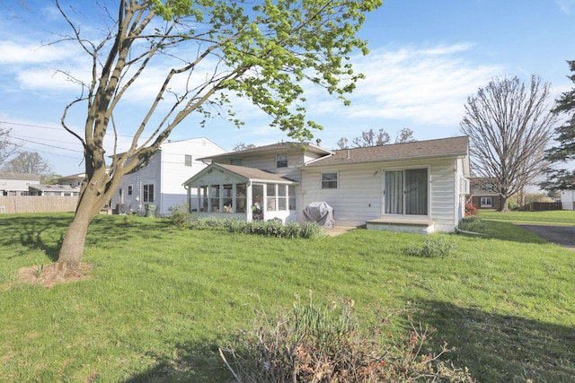 6693 Red Coach Ln, Reynoldsburg, OH 43068 - rear view of property with a sunroom and a lawn