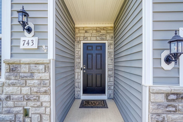 entrance to property with stone siding