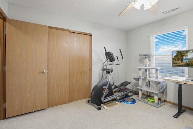 workout room featuring carpet, visible vents, and ceiling fan