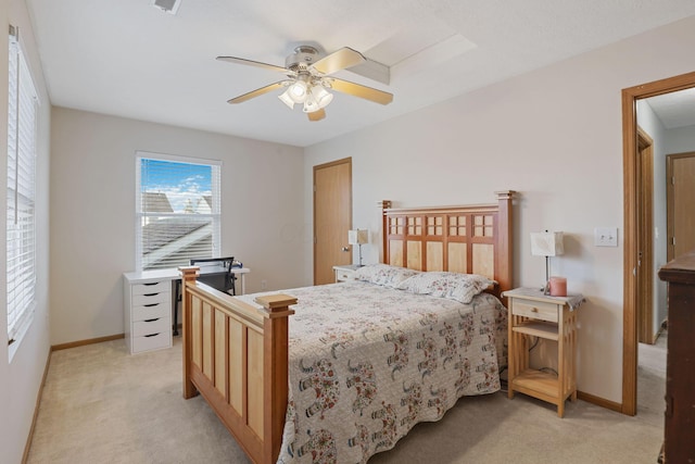 bedroom featuring light carpet, ceiling fan, and baseboards
