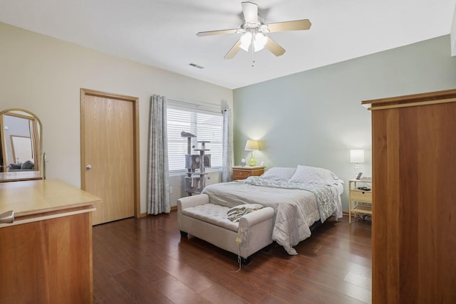 bedroom with visible vents, dark wood-style flooring, and a ceiling fan