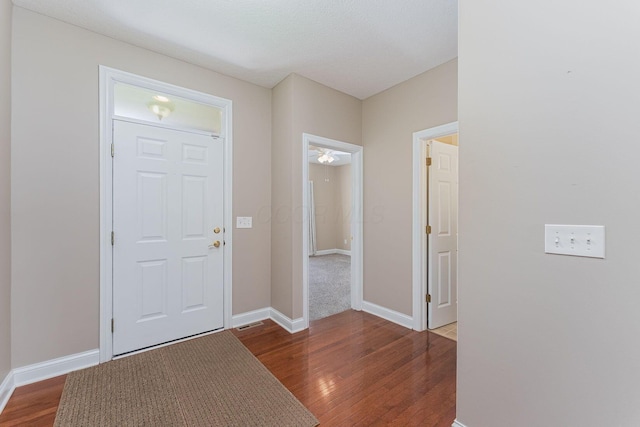 entrance foyer with baseboards and wood finished floors