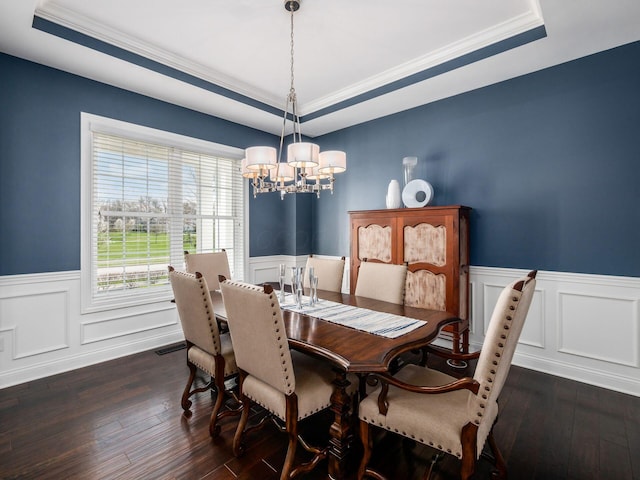 7251 Wilton Chase St, Dublin, OH 43017 - dining space with dark wood-type flooring, a tray ceiling, a wainscoted wall, and a chandelier