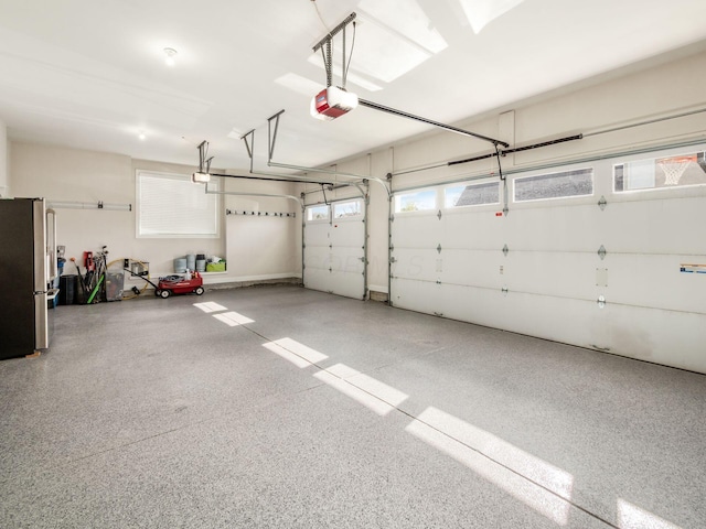 7251 Wilton Chase St, Dublin, OH 43017 - garage with freestanding refrigerator and a garage door opener