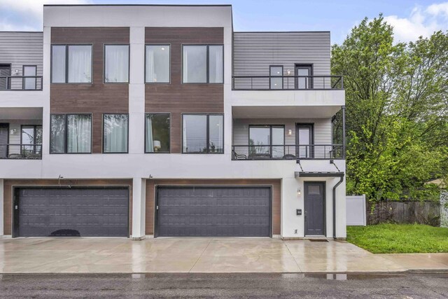 362-366 Zimpfer St Unit 1-3, Columbus, OH 43206 - multi unit property featuring a garage, driveway, stucco siding, and a balcony