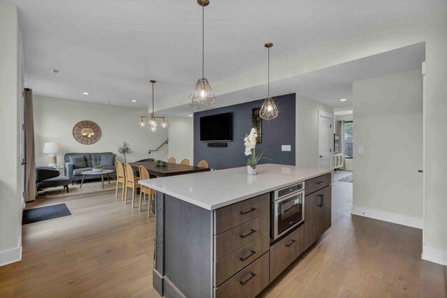 362-366 Zimpfer St Unit 1-3, Columbus, OH 43206 - kitchen featuring open floor plan, modern cabinets, light wood-style flooring, light countertops, and oven