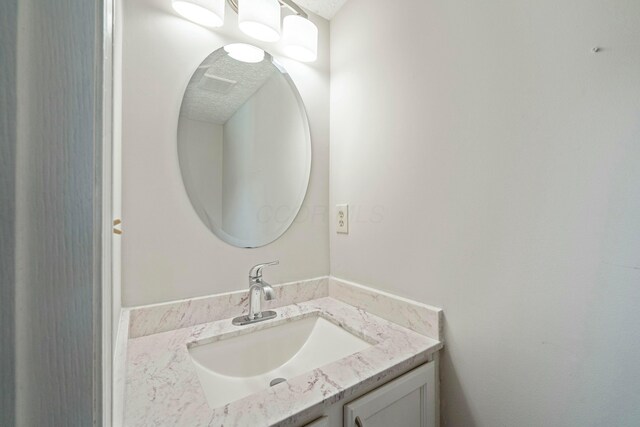 bathroom featuring vanity and a textured ceiling