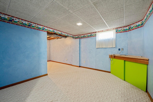 basement featuring baseboards and carpet floors