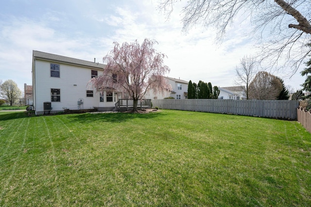 view of yard featuring central air condition unit and fence