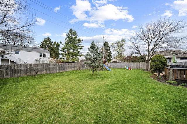 view of yard featuring a fenced backyard and a playground