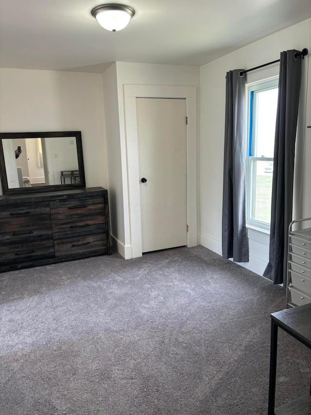carpeted bedroom with baseboards