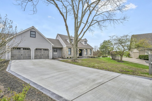 view of front of home featuring a front lawn, concrete driveway, and stone siding