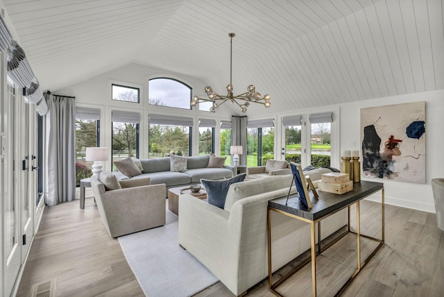 living room featuring light wood-style flooring, a chandelier, visible vents, french doors, and high vaulted ceiling