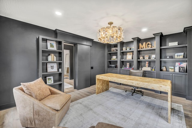 home office featuring recessed lighting, an inviting chandelier, built in features, and wood finished floors