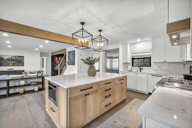 kitchen with recessed lighting, a chandelier, built in appliances, a sink, and light wood-type flooring