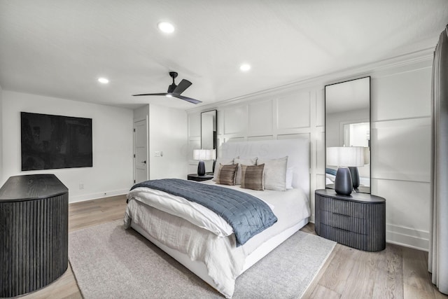bedroom featuring recessed lighting, a ceiling fan, light wood-style flooring, and baseboards