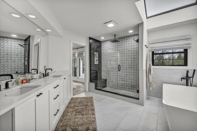 full bath with a stall shower, recessed lighting, and a sink