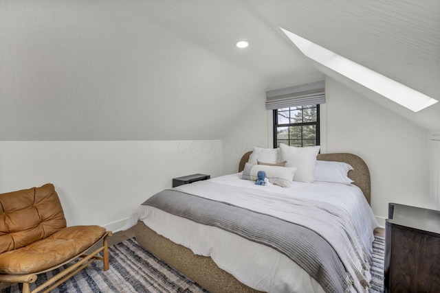 bedroom with recessed lighting, vaulted ceiling with skylight, carpet floors, and baseboards