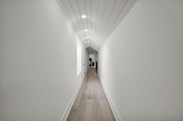 hallway with recessed lighting, light wood finished floors, and baseboards
