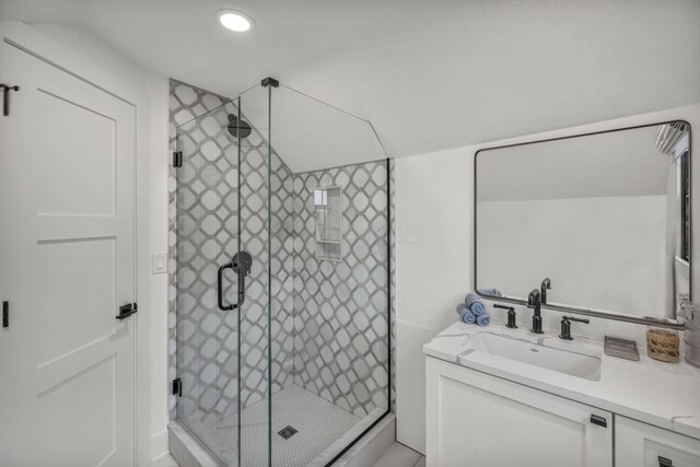 bathroom featuring a stall shower and vanity