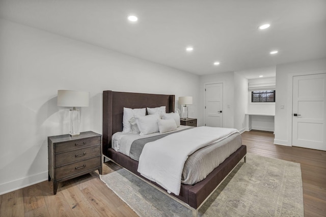 bedroom featuring recessed lighting, wood finished floors, and baseboards
