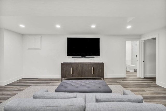 living area with baseboards, recessed lighting, and wood finished floors