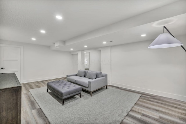 living room featuring light wood-style floors, recessed lighting, and baseboards