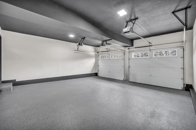 garage featuring baseboards and a garage door opener