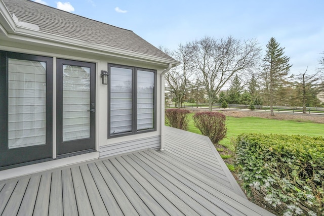 deck featuring fence and a yard