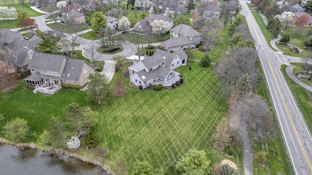 drone / aerial view featuring a residential view and a water view