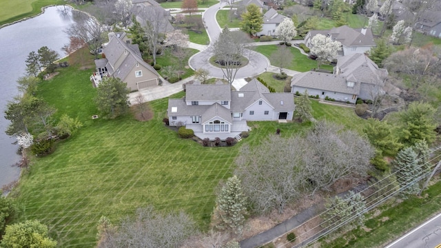 birds eye view of property with a residential view and a water view