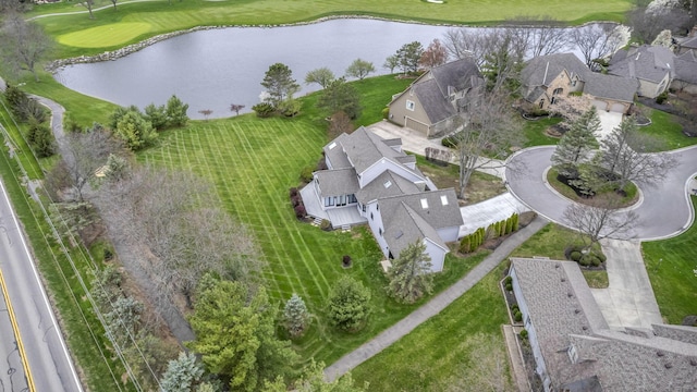 birds eye view of property with a residential view, a water view, and view of golf course