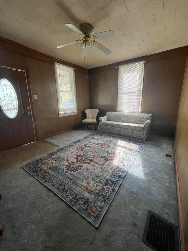 334 N High St, Caledonia, OH 43314 - carpeted entryway featuring wooden walls, a ceiling fan, and visible vents