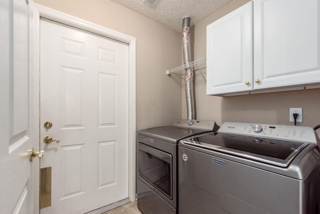 3673 Stoneway Pt, Powell, OH 43065 - washroom with separate washer and dryer, cabinet space, and a textured ceiling