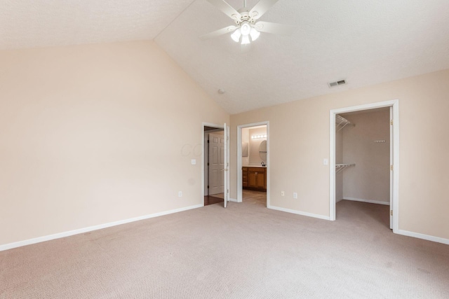 3673 Stoneway Pt, Powell, OH 43065 - unfurnished bedroom with a walk in closet, light carpet, lofted ceiling, baseboards, and a closet