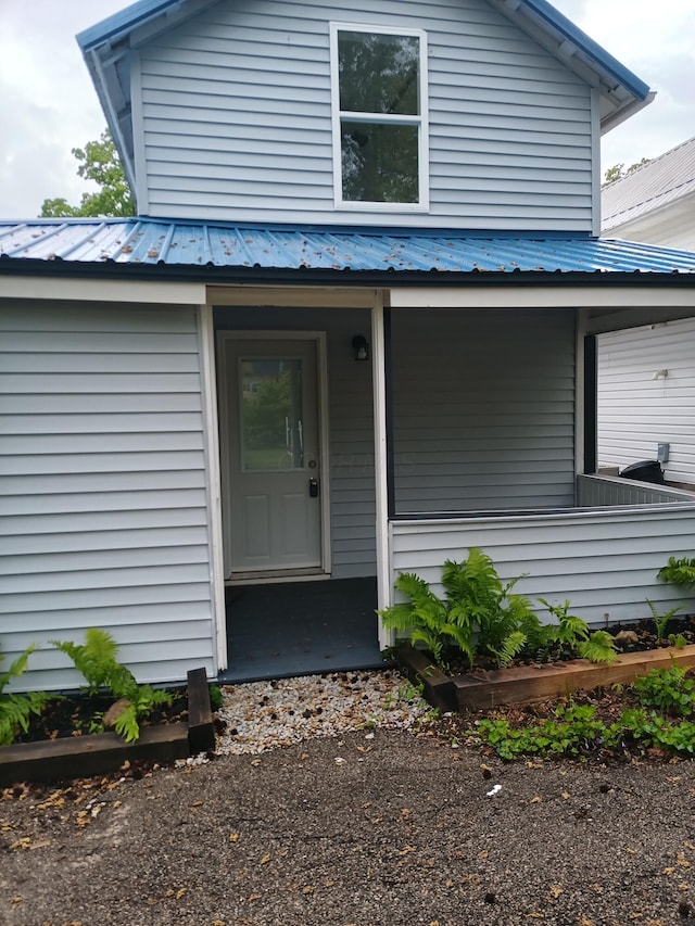 126 7th St, Lancaster, OH 43130 - view of exterior entry featuring covered porch and metal roof